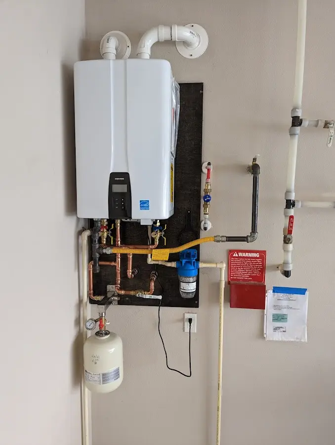 Professional plumber installing copper piping in a Knoxville home